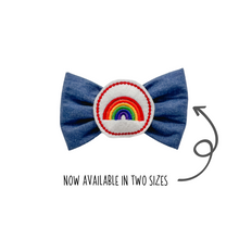 Load image into Gallery viewer, Denim chambray Bow Tie with embroidered rainbow center made with Alligator hair clip, over the collar or elastic headband (2 sizes available)
